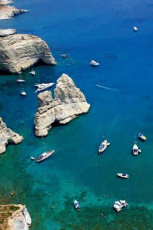 Kleftiko in Milos attracts thousands of visitors every year who enjoy the crystal-clear waters by the impressive white cliffs.